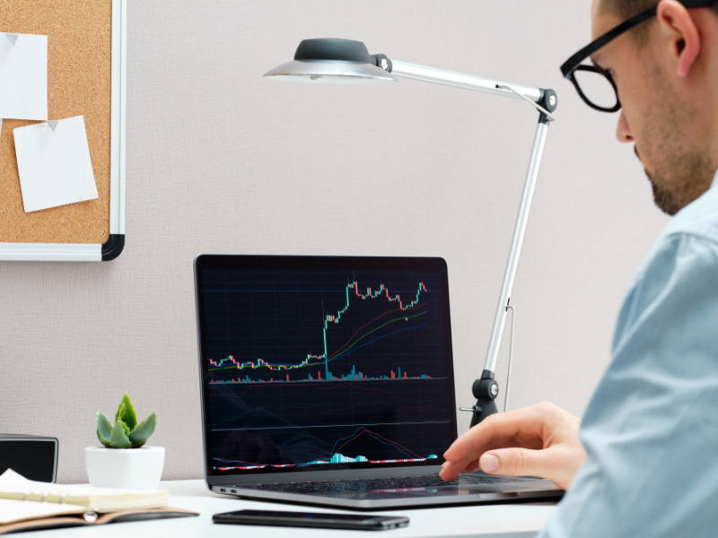 Investor Watching The Change Of Stock Market On Notebook