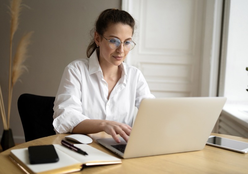 A Woman With Glasses Is A Freelancer Working In An