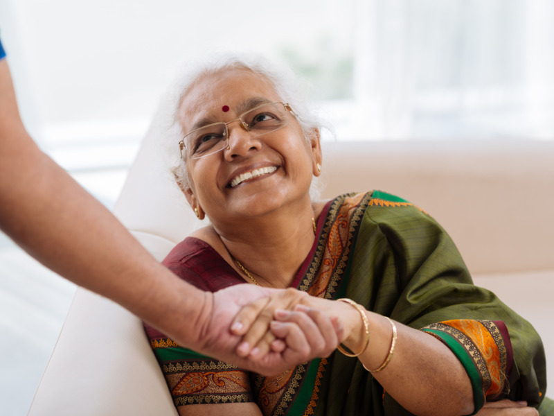 Happy Old Lady Holding A Hand Of Her Husband And